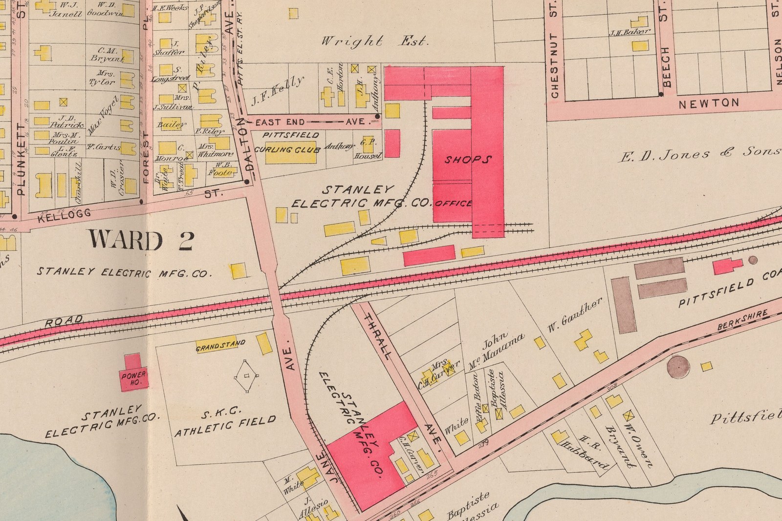 Plate 6, Pittsfield: the Stanley Electric Mfg. Co. The name is lettered four times on this sheet. Top center, the brick works with SHOPS and OFFICE and a rail spur curving in off the Boston and Albany. Below the tracks, company land twice more, holding the brick POWER HO. beside Silver Lake, and the S. K. C. ATHLETIC FIELD with its diamond and a wooden GRANDSTAND. Bottom center, a second brick plant between Jane and Thrall Avenue. Bottom right, the stone buildings and round gasholders of the Pittsfield Coal Gas Co.