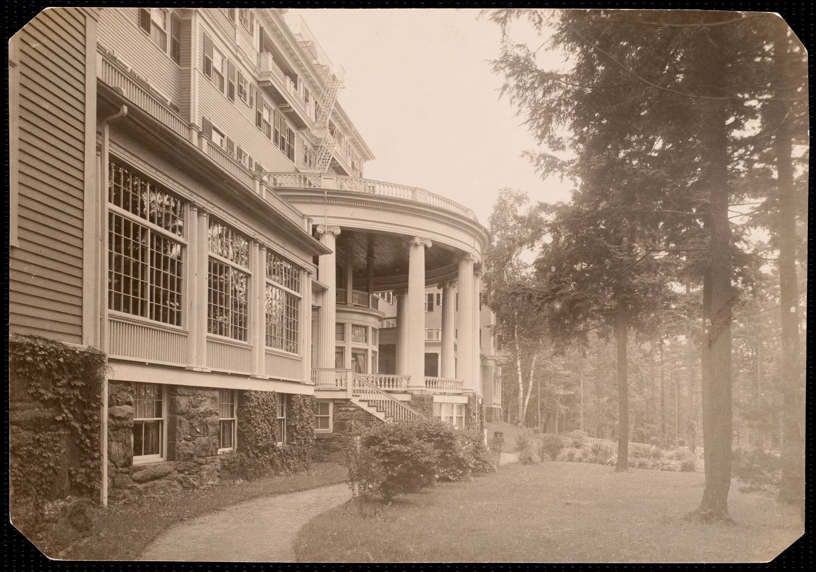 Aspinwall Hotel: back entrance, curves out, trees. about 1902–1918.