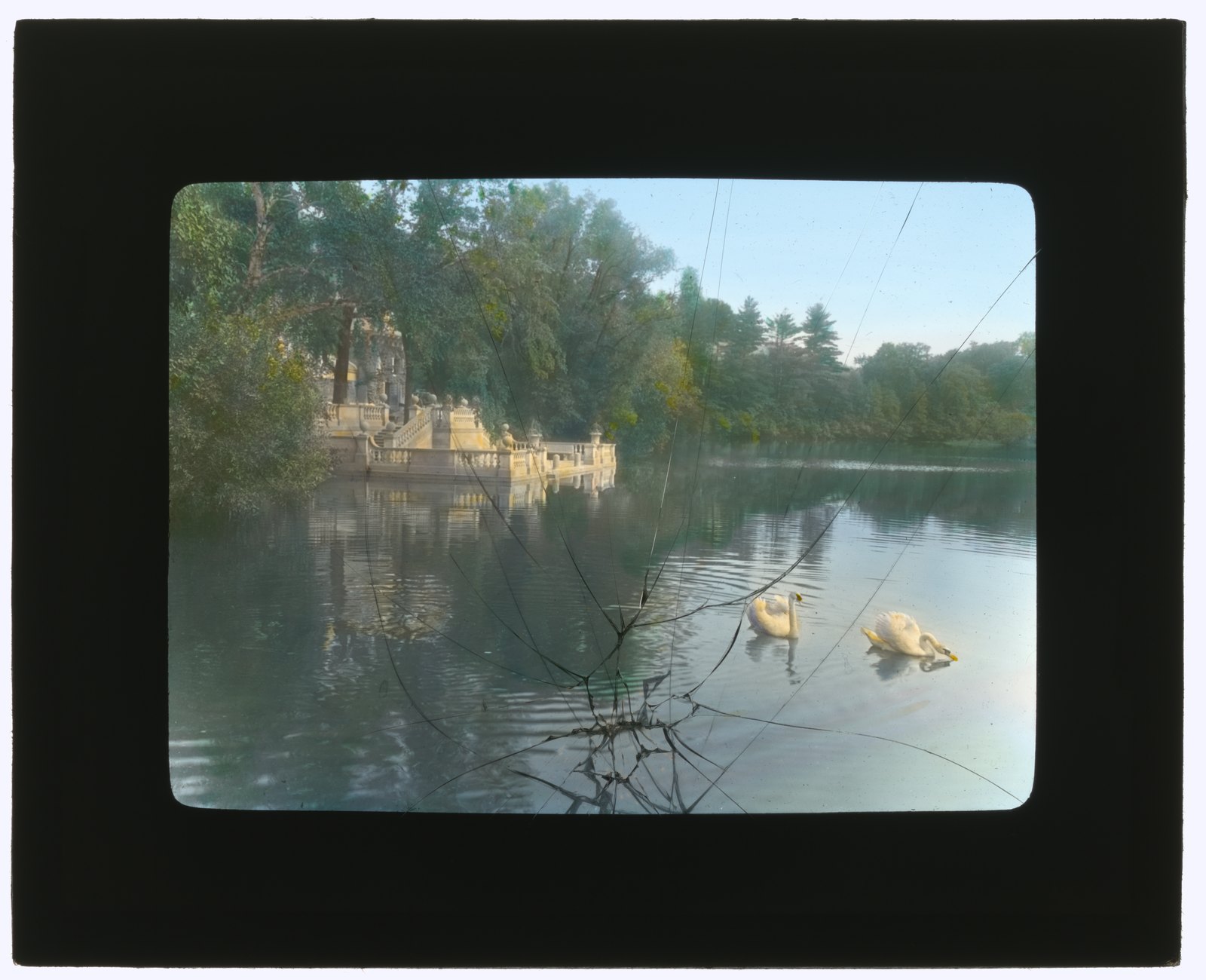“Boat landing.” Swans on the water, the landing and its balustrade beyond.
