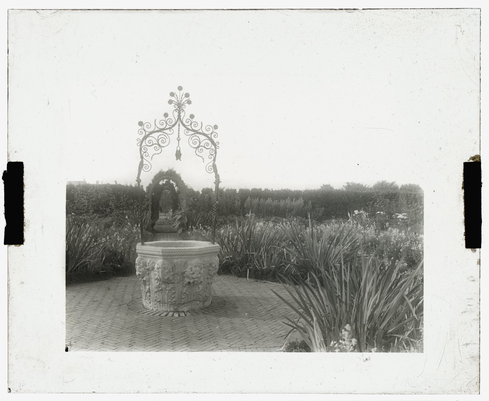 “Well head.” A wrought-iron well head in the garden. The only one of the eight slides left uncolored.