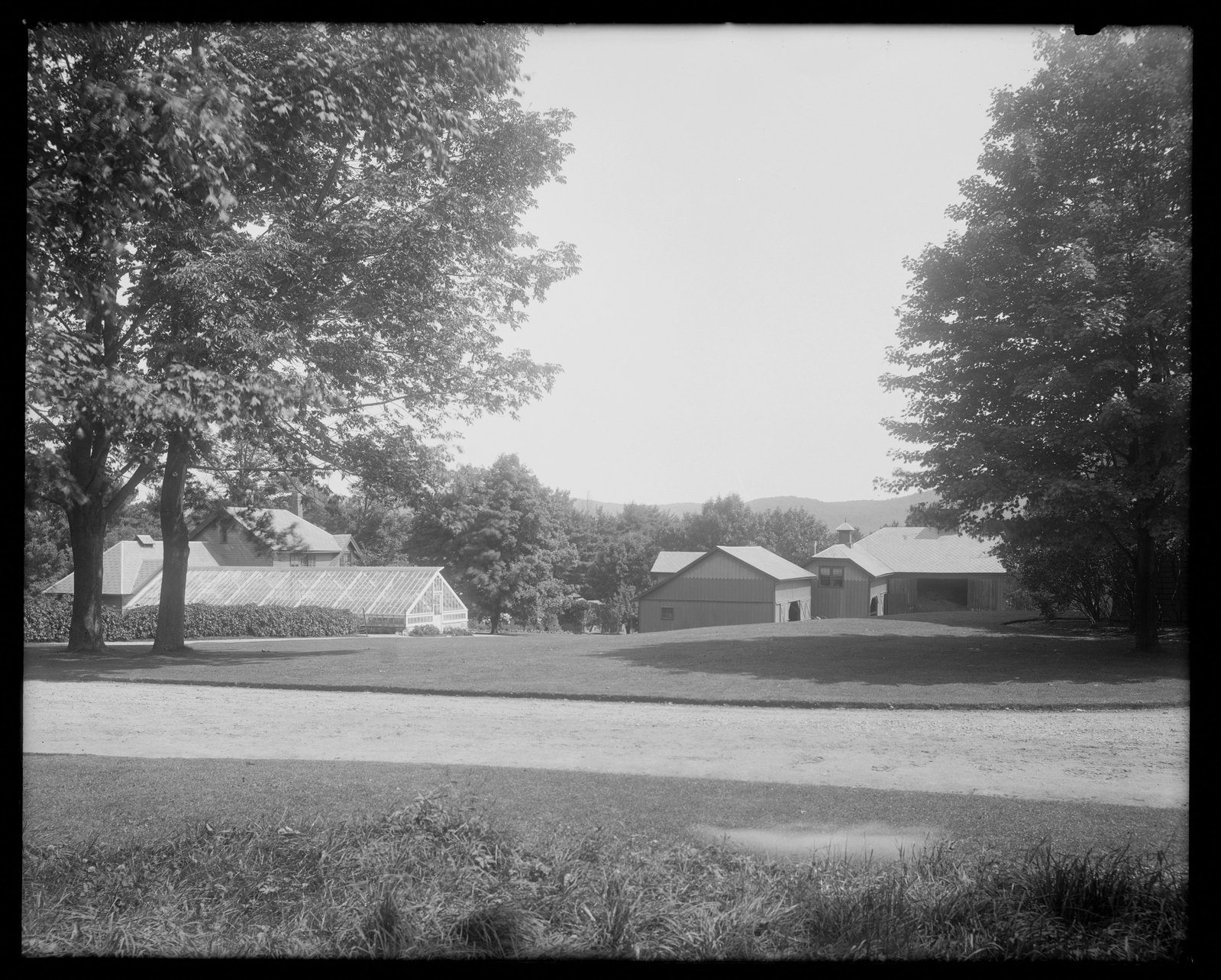 Coldbrook: stables and greenhouse. About 1892–1915.