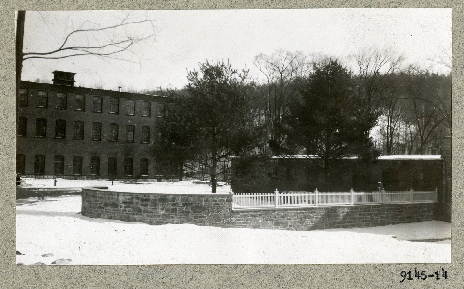 The finished wall and fence in snow. Print 9145-14.
