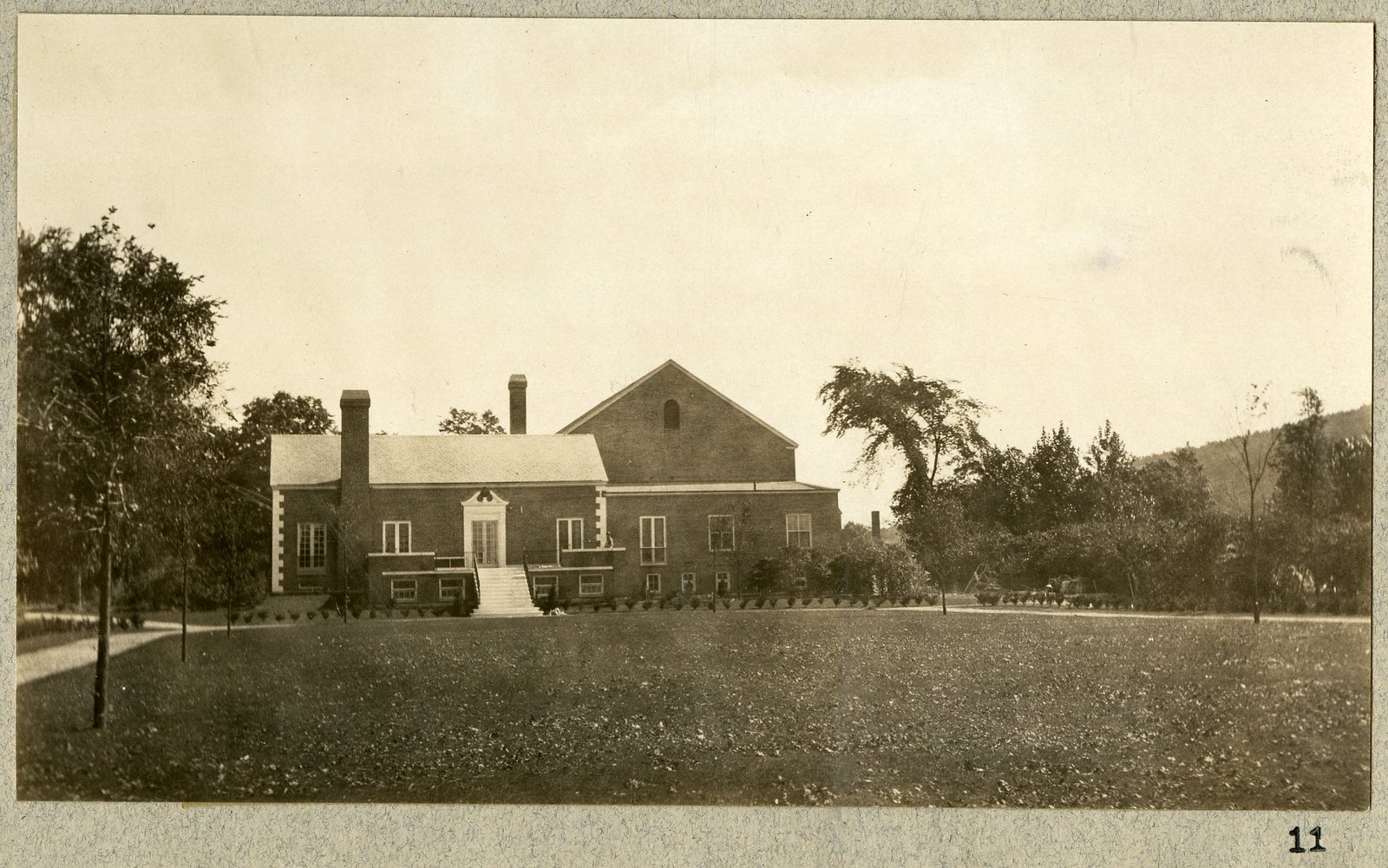 The Community House from the east, with young trees. Print 11.
