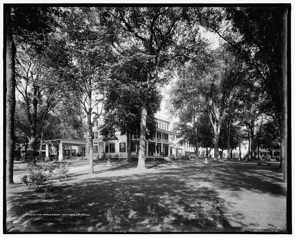 The same building between 1900 and 1915, from nearly the same ground: the trees grown up, the verandas extended.