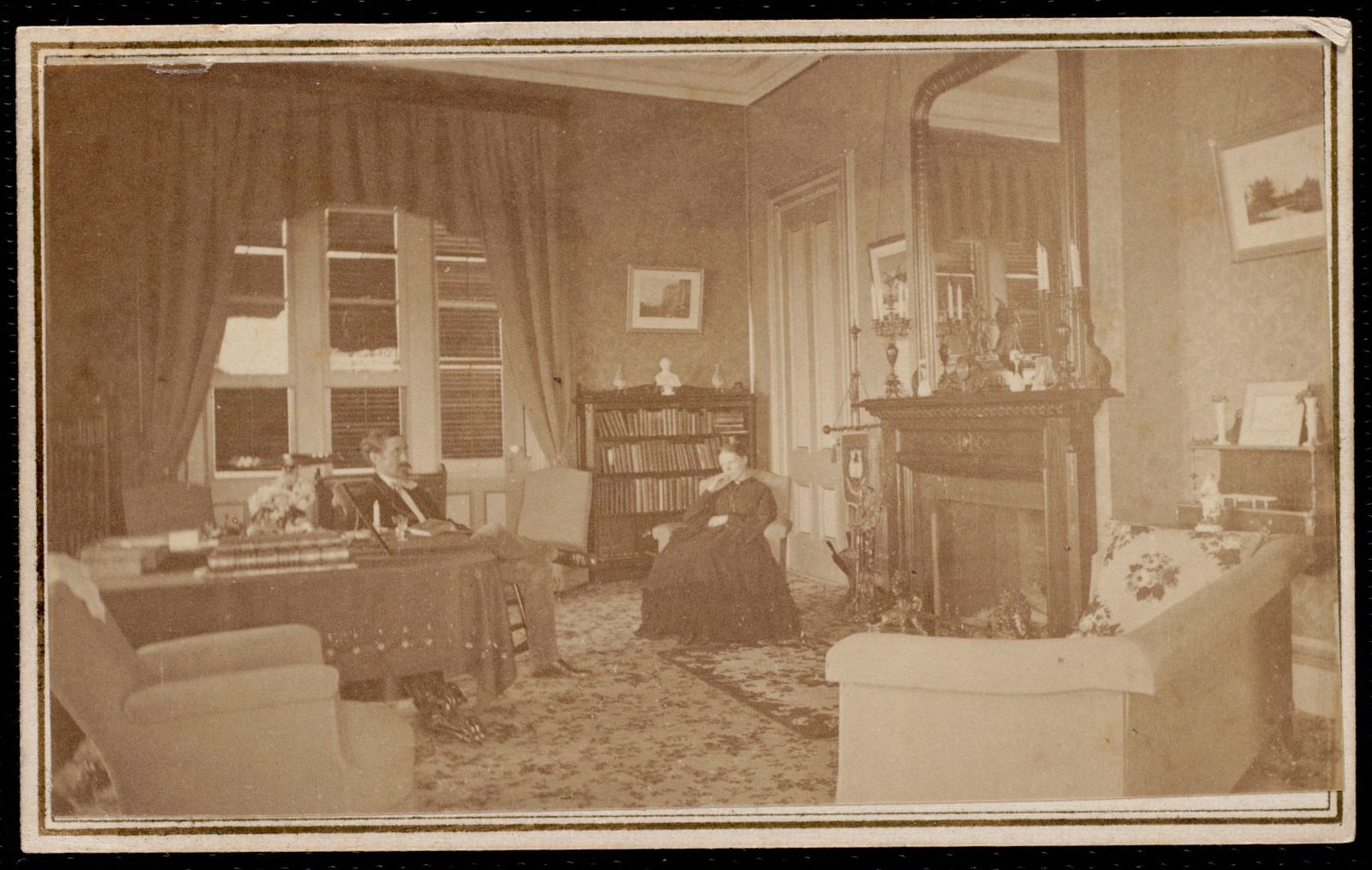 Dormers: man and woman seated in living area. About 1868–1893.