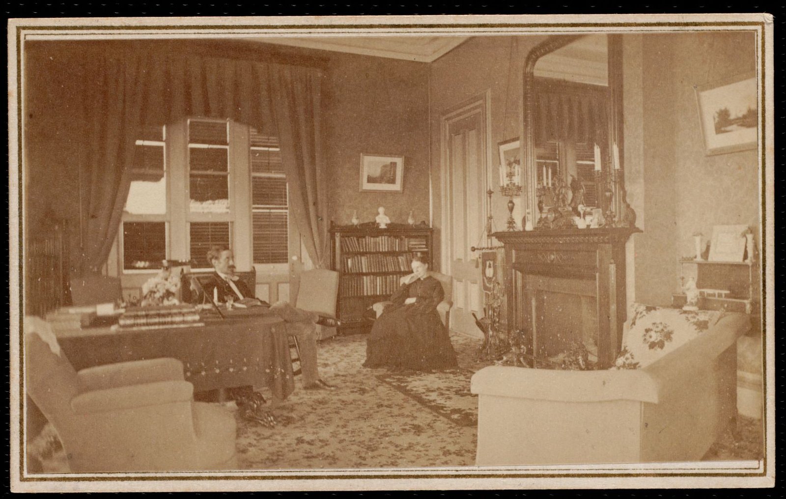 Dormers: man and woman seated in living area. About 1868–1893.