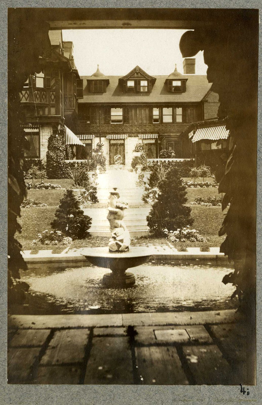 Photograph 4, July 1924. A fountain seen through a doorway, the house beyond.