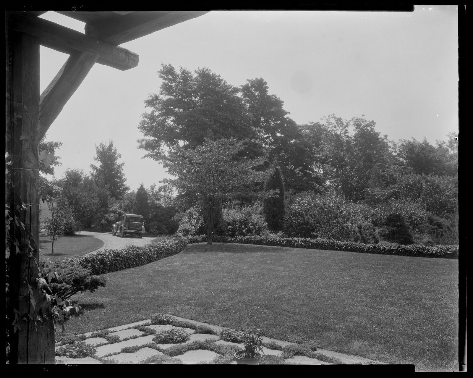 Garden landscape with car. About 1925–1935.