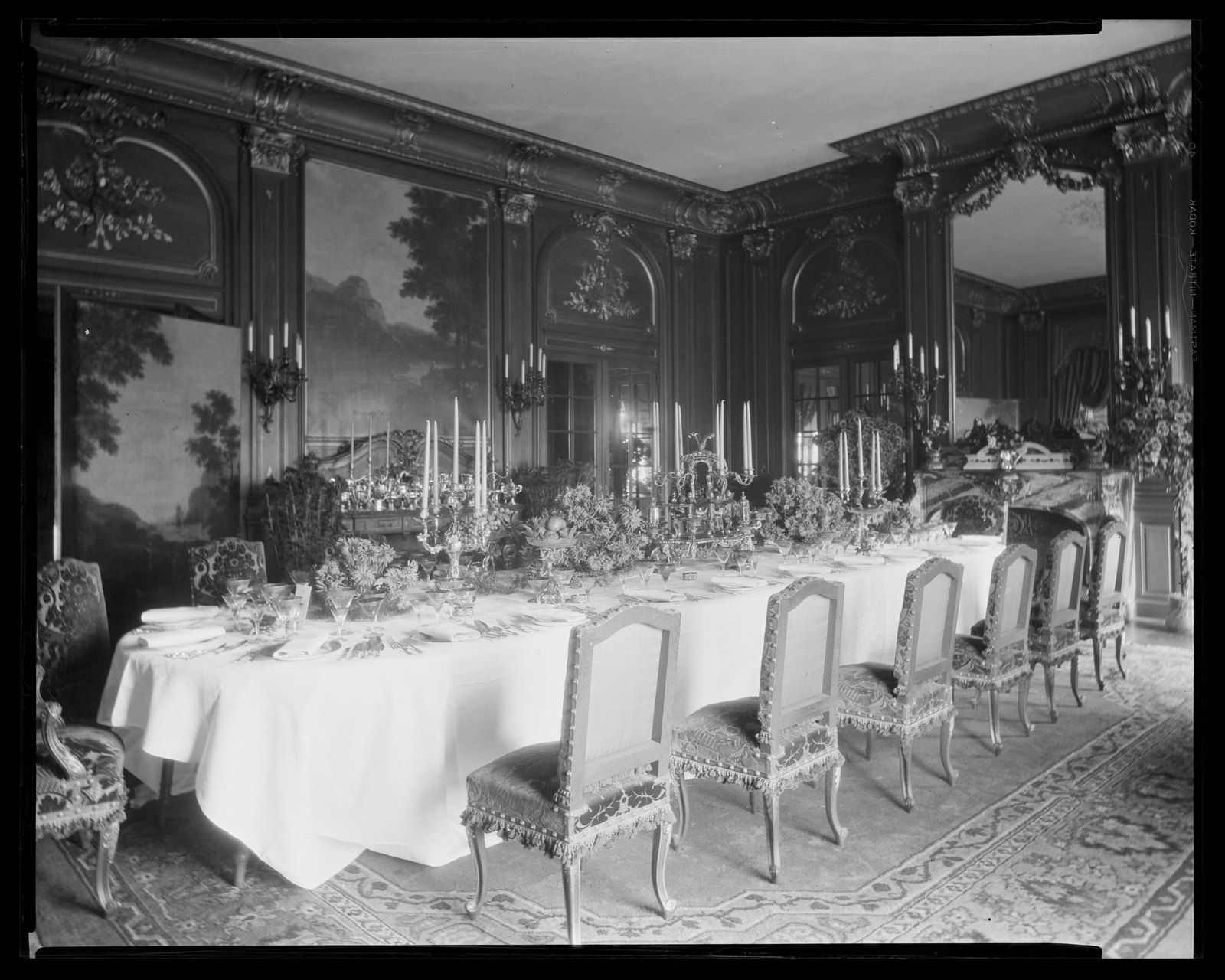 The dining room at Bellefontaine, laid for dinner. Carrere and Hastings drew the room; the chairs, the table, the carpet, the hangings and the lights are somebody else’s contract entirely.