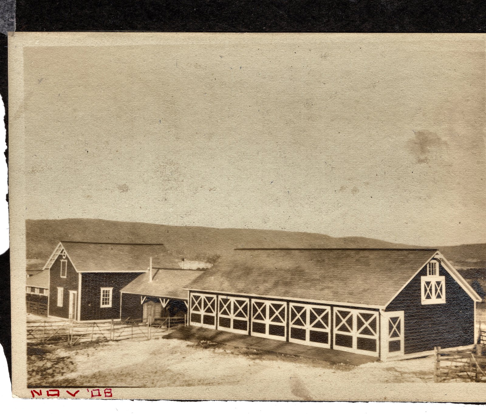 The cow barn and its white cross-braced fencing. Stamped NOV. 08 on the mount.