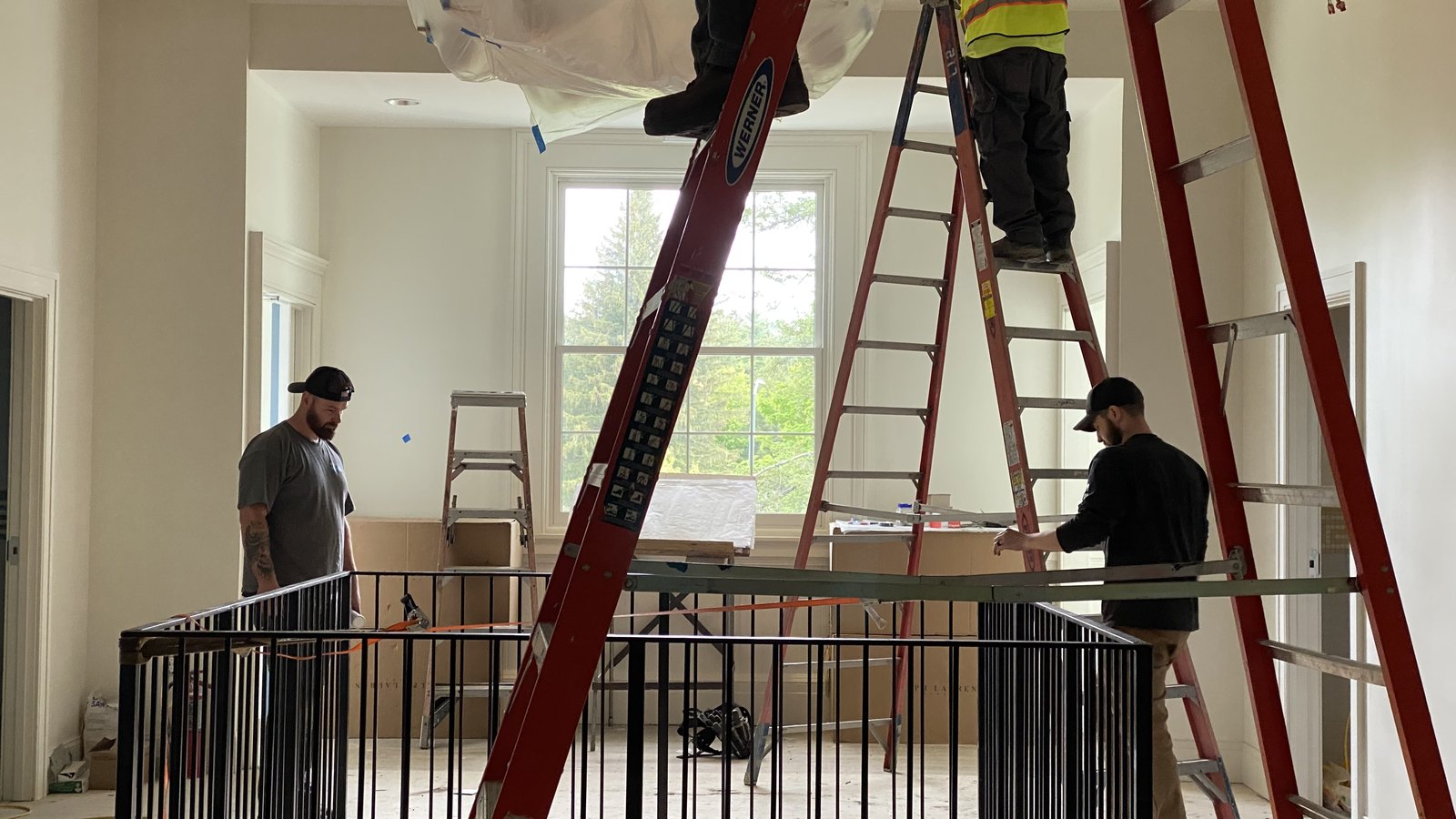 Inside during the work: the new stair and the upper hall being finished.