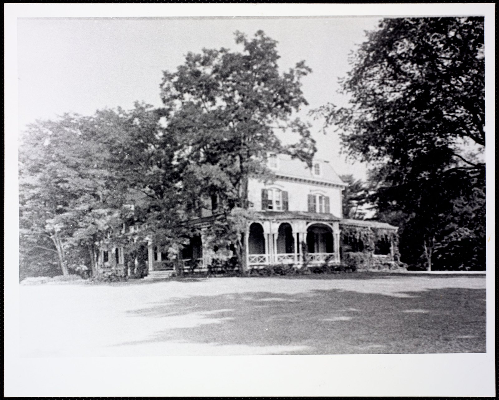 House surrounded by trees. About 1910–1920.