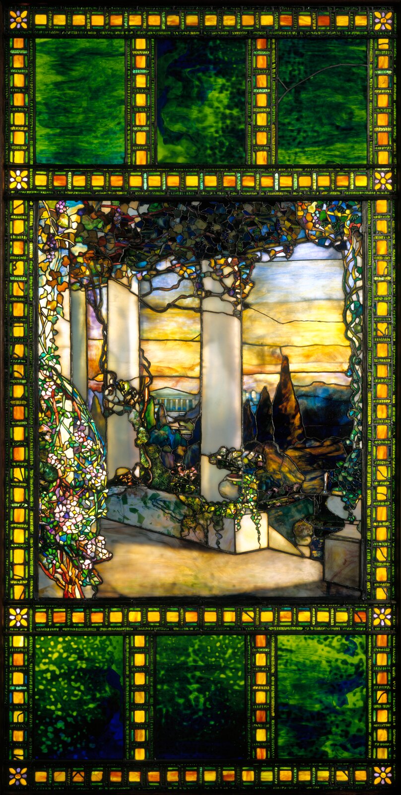 The whole window: eighty-nine inches by forty-five, thousands of pieces, and a border of green and amber squares that does nothing but hold the eye in. The Hinds house was pulled down in 1930. The window is what is left of it.