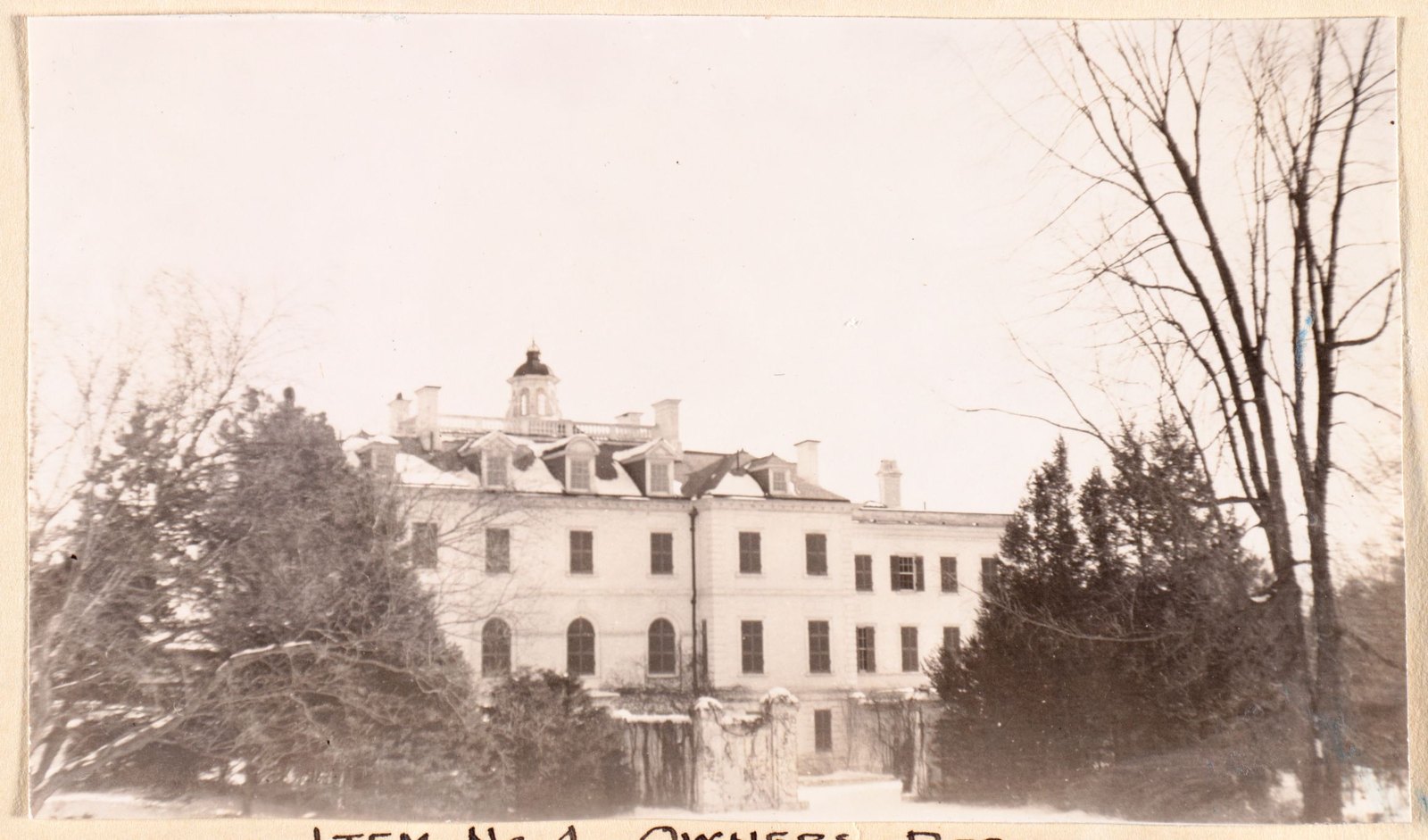 Item #4, owner’s residence — the house itself, through the bare trees.