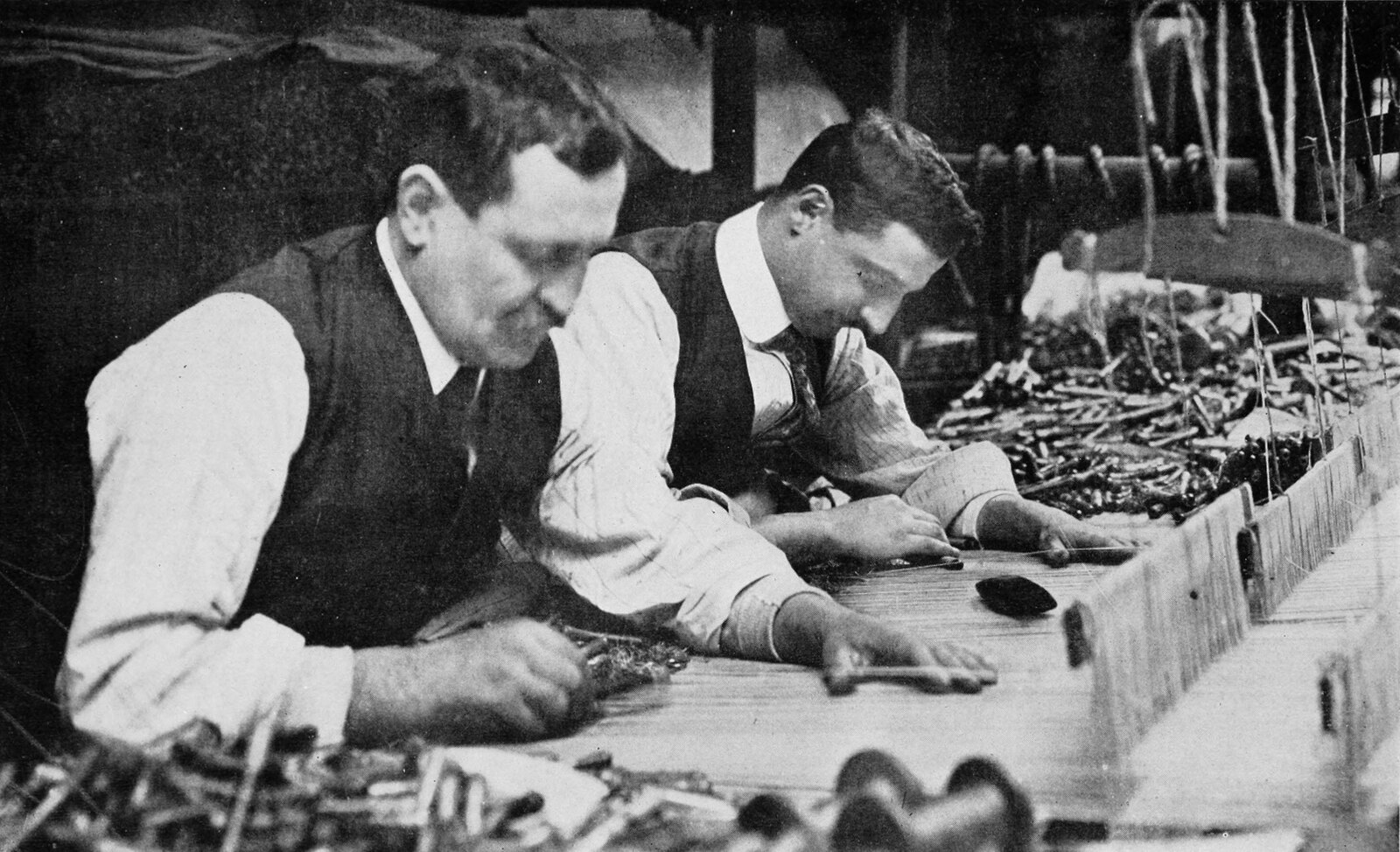 Two of the Williamsbridge weavers at the loom, about 1912. Between them they could finish something the size of a dinner plate in a good day.