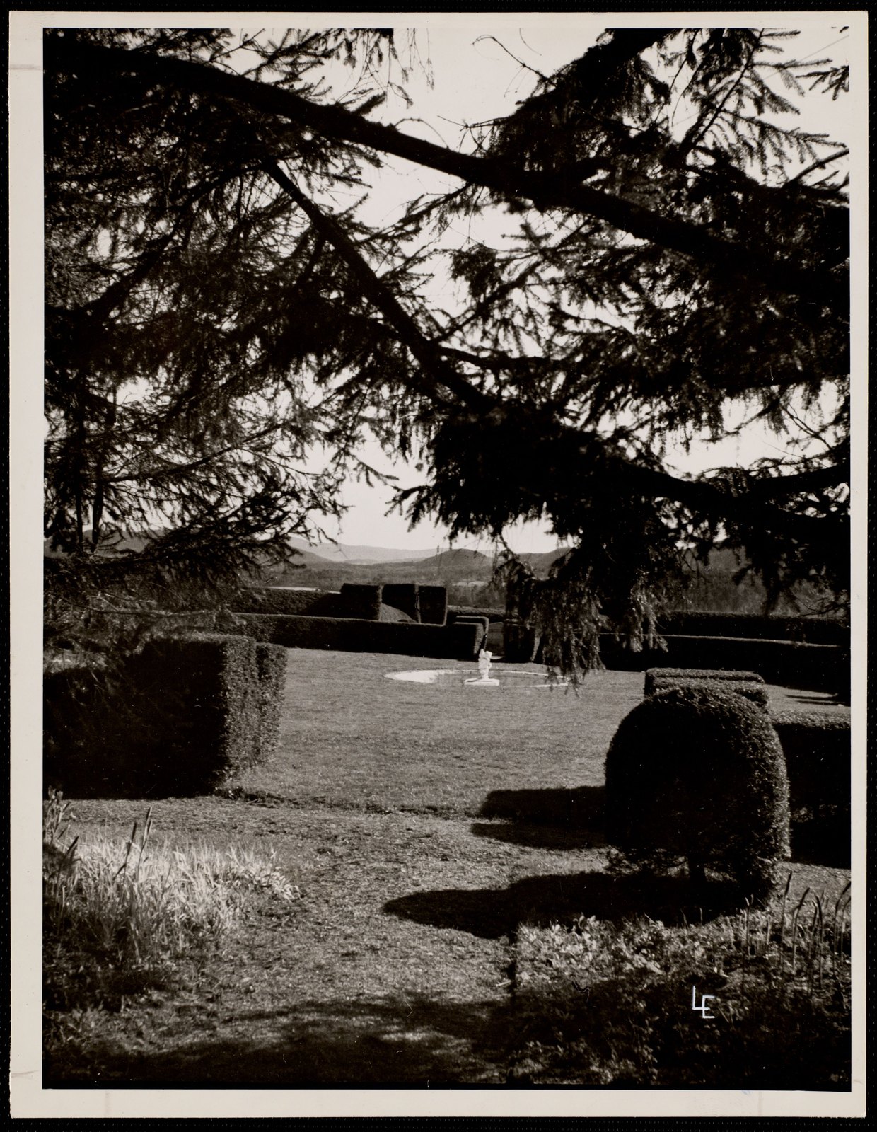 “Tanglewood: lawn view with fountain,” about 1937–1960: clipped hedges, a fountain in its basin, and the hills across the Bowl.
