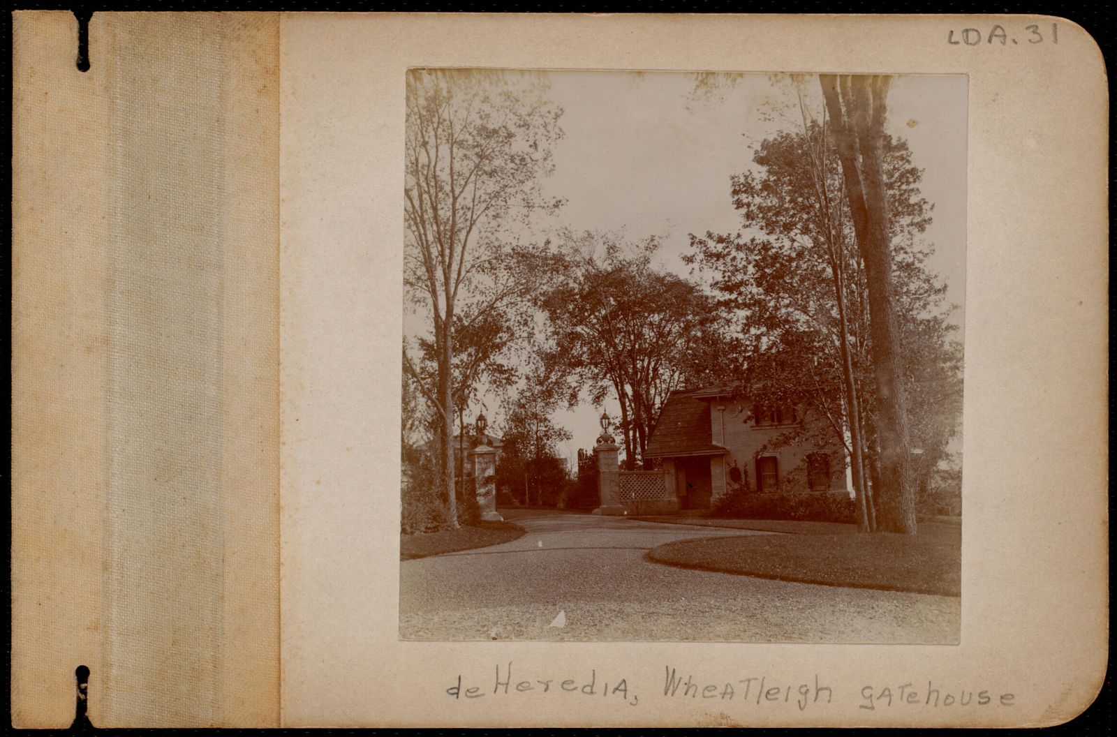 The brick lodge and gate piers. Album caption: “deHeredia, Wheatleigh gatehouse.”
